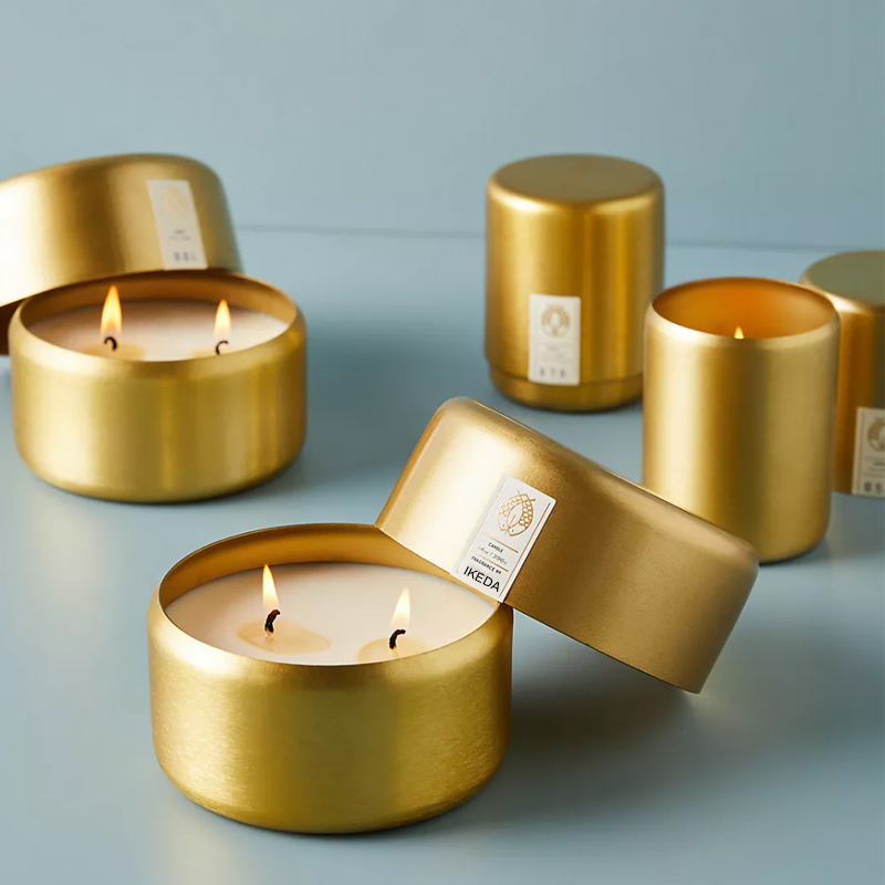 Gift box set of three soy wax candles in citrus and herbal scents, with branded packaging.