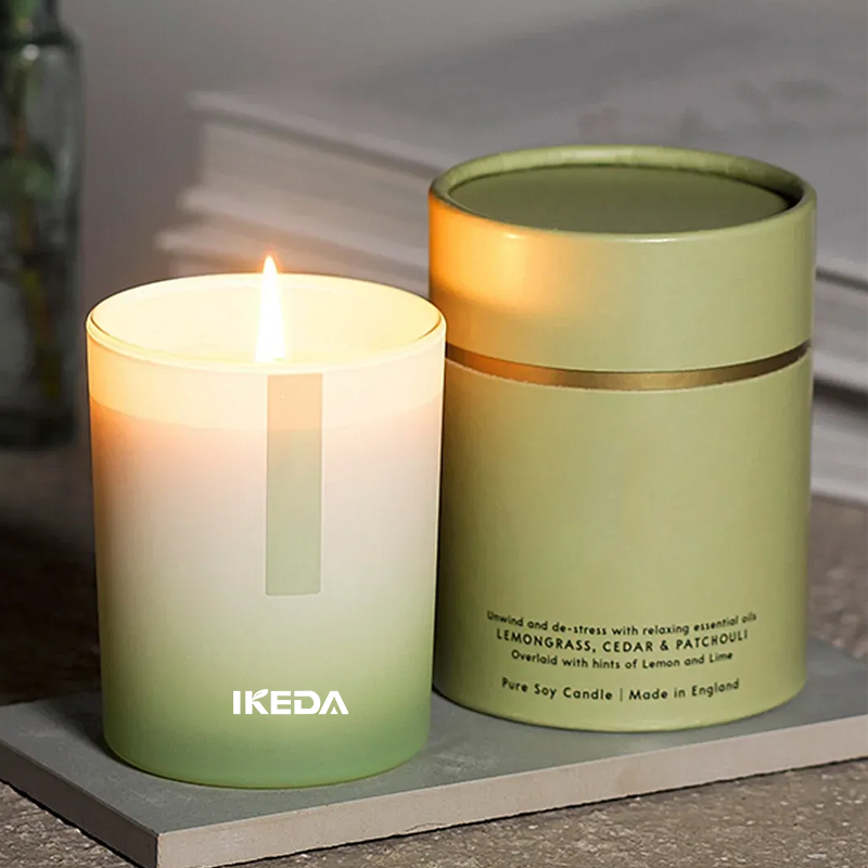 Clear glass jar candle with fresh linen and sea breeze scent, shown on a restaurant table setting.