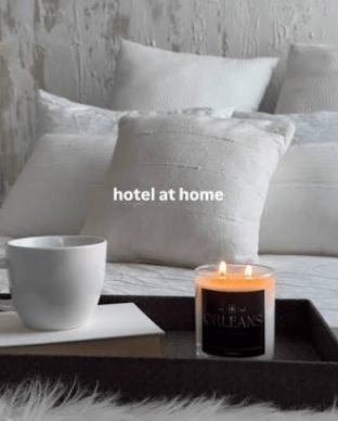 custom scented candle amenity in luxury hotel room